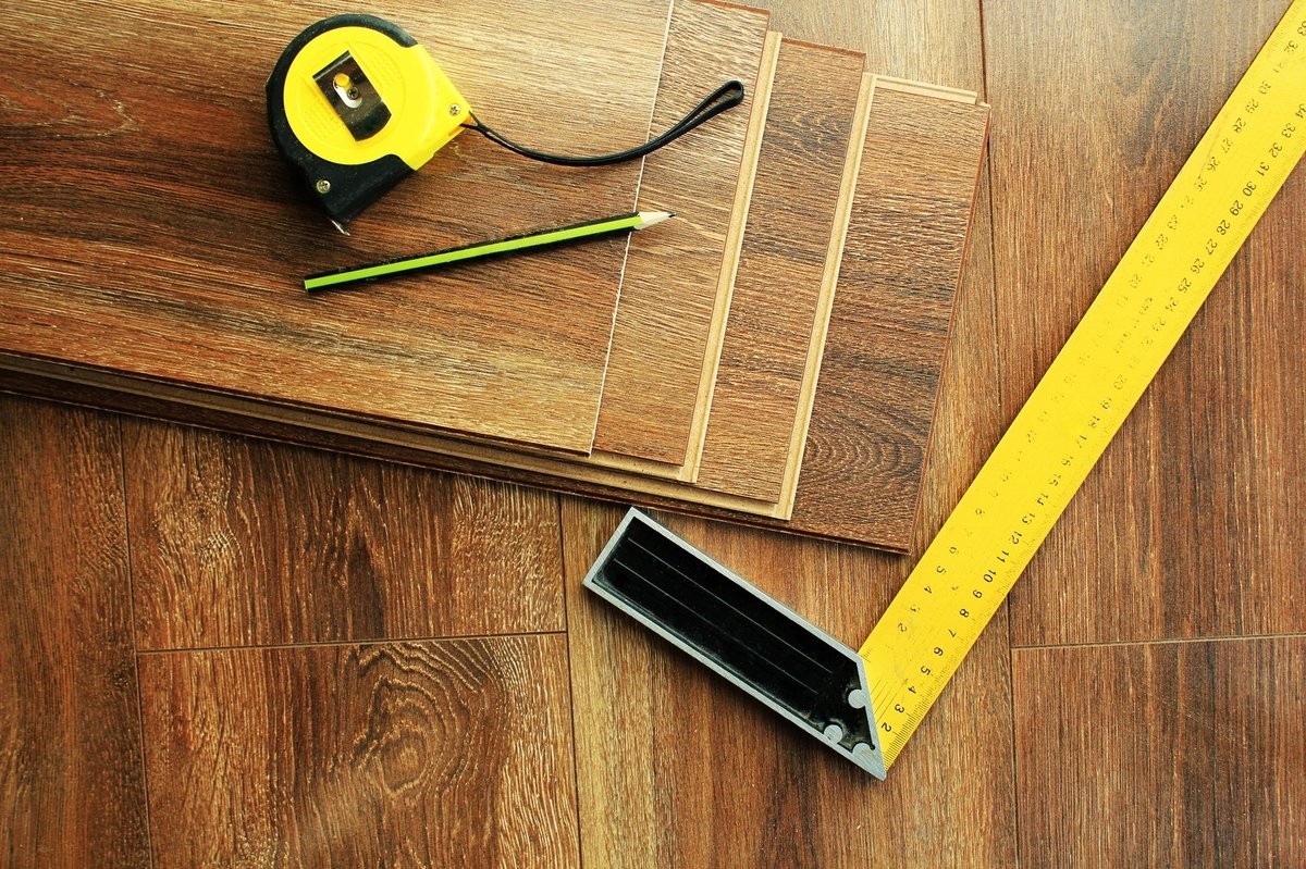 laminate flooring planks, measuring tape,pencil