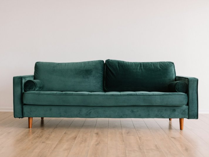 Stylish sofa on vinyl plank flooring